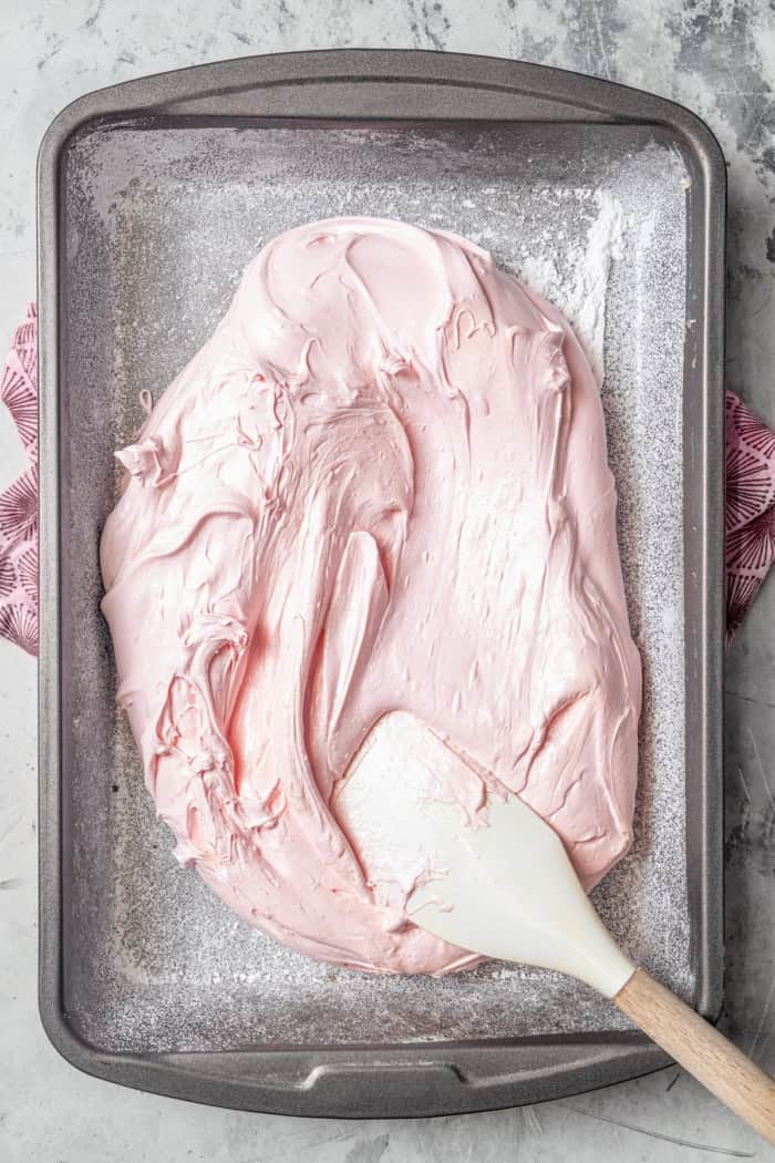 Homemade Marshmallow Hearts are the very best way to send a little love on Valentine’s Day — or any time of year. Fluffy, puffy, and sweet! Spreading marshmallow mixture onto pan