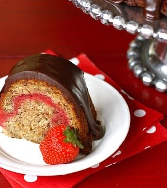 This slice of banana split bundt cake is the perfect dessert - filled with fresh strawberry and topped with rich chocolate.