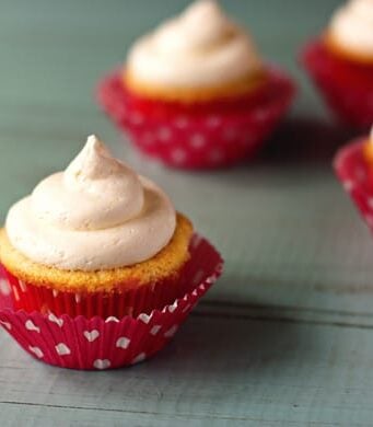 frosted cupcakes with pink wrappers