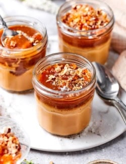 3 caramel pots de creme in glass jars.