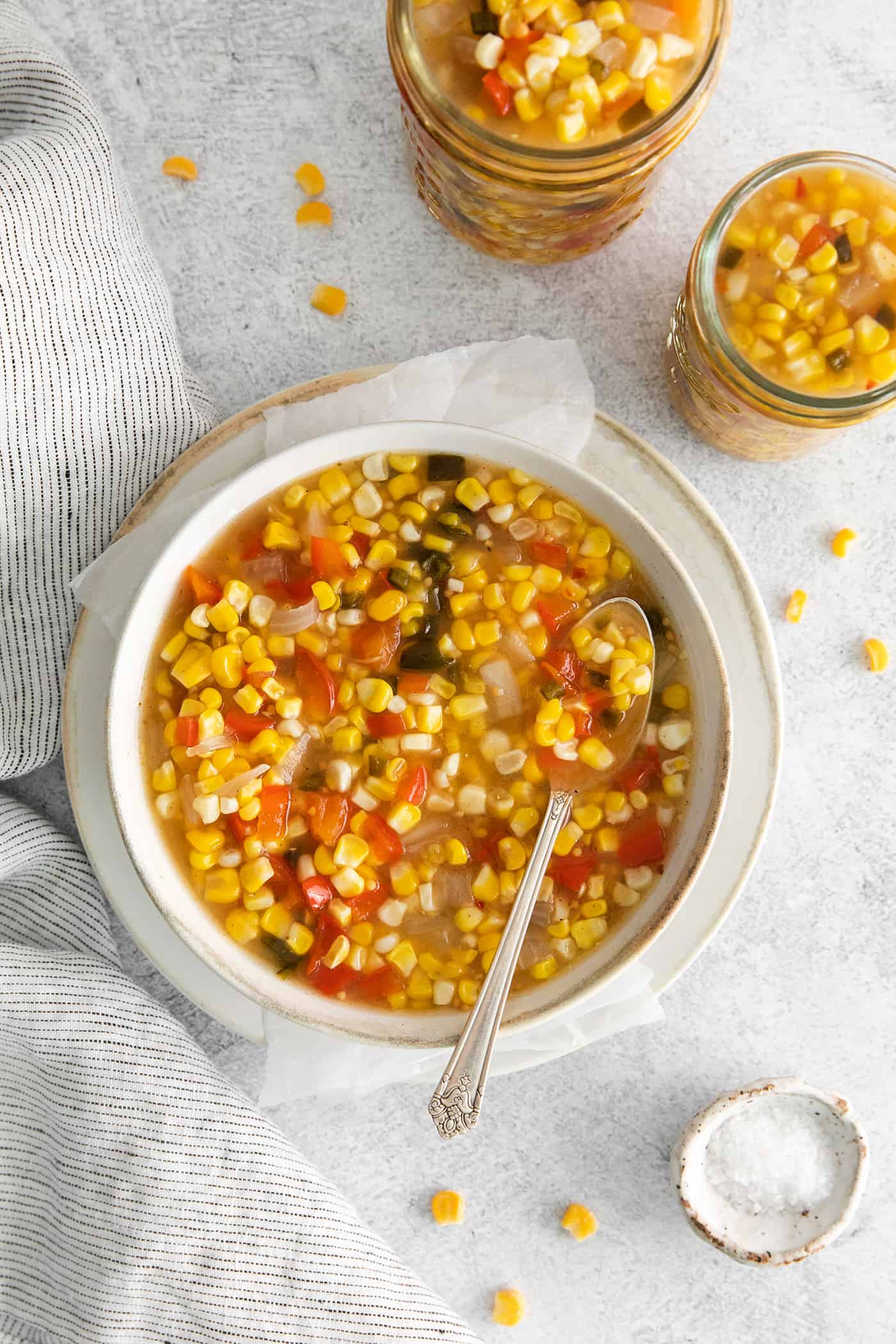 Made with fresh sweet corn, peppers, and onion this Zesty Sweet Corn Relish is just what you need to spice up dishes from tacos to burgers. Sweet corn relish being spooned into jars