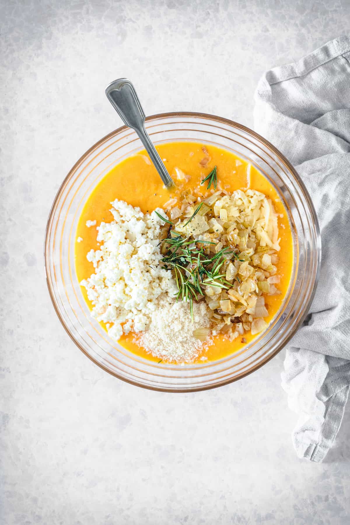 Eggs, cheese and other butternut squash tart ingredients in a bowl