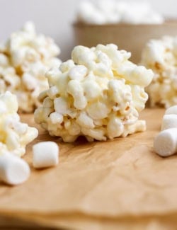 Marshmallow popcorn ball on parchment paper.
