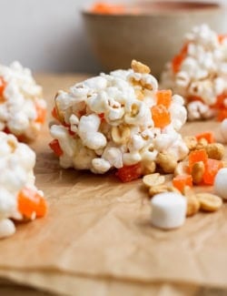 Marshmallow popcorn ball made with peanuts and orange gumdrops.