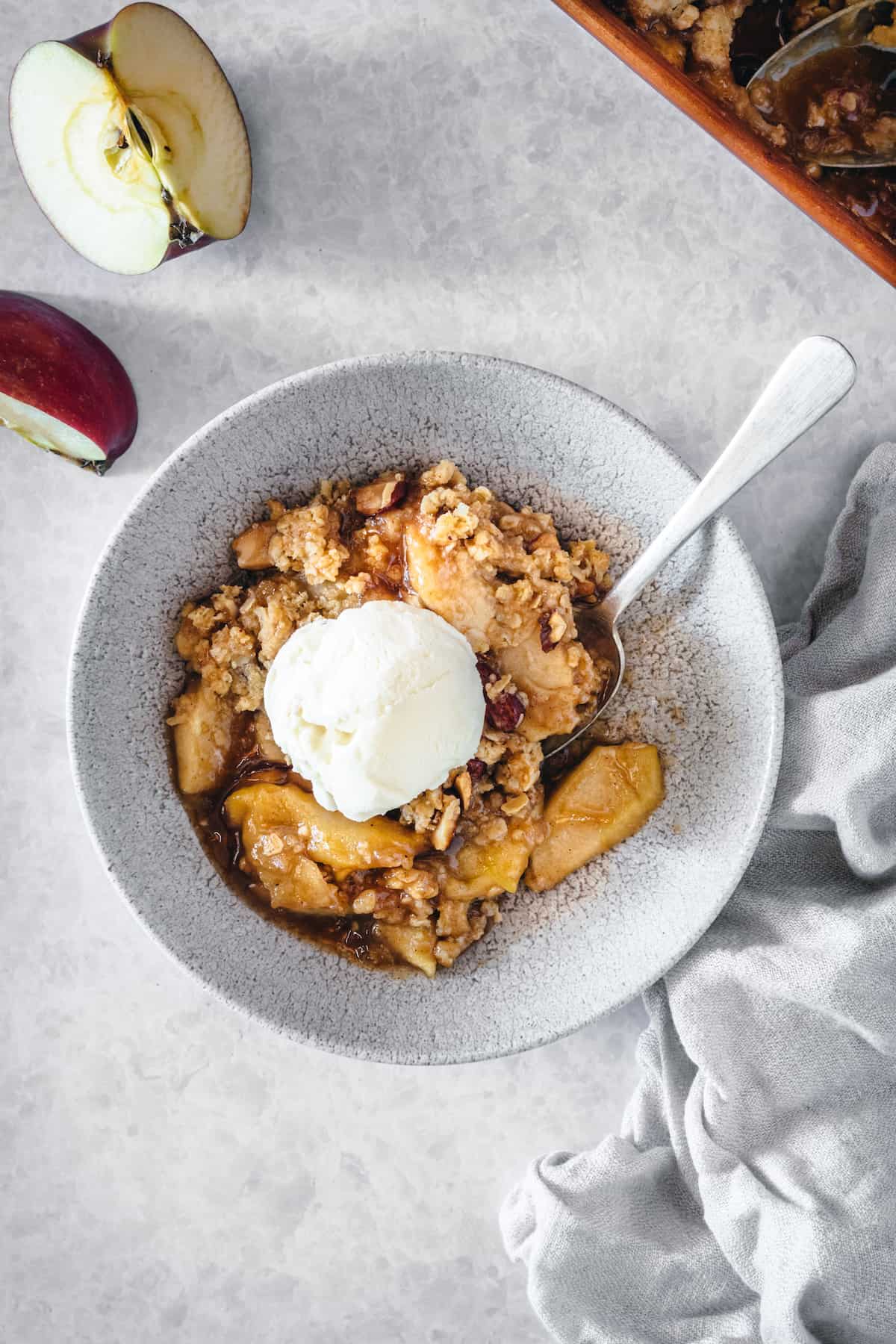 Overhead view of caramel apple crisp topped with ice cream