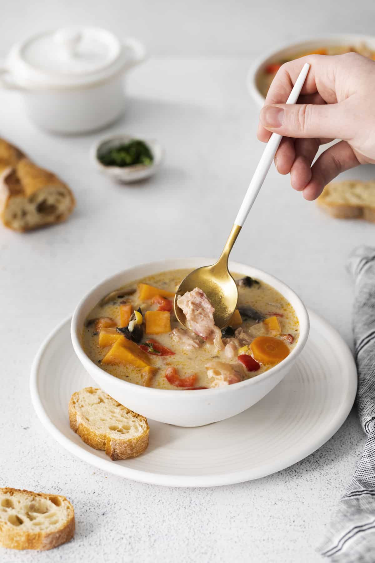 Make this easy Smoked Turkey Chowder recipe in one pot. It's lightly creamy and loaded with flavor, a great way to use up turkey leftovers! A spoon stirring a bowl of smoked turkey chowder