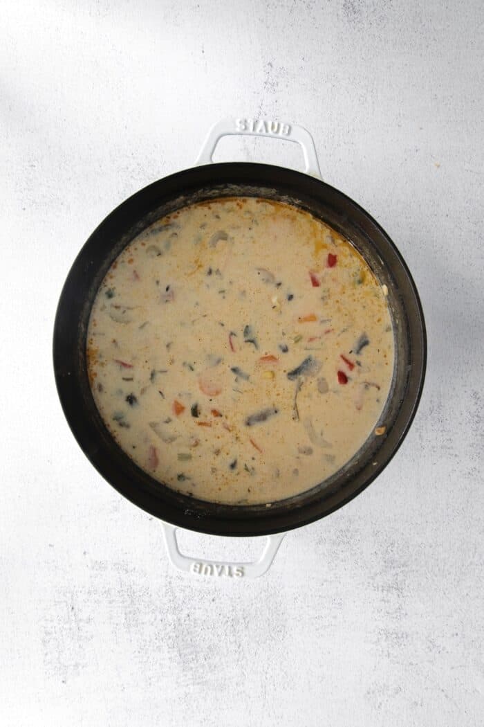 Make this easy Smoked Turkey Chowder recipe in one pot. It's lightly creamy and loaded with flavor, a great way to use up turkey leftovers! Overhead view of turkey chowder cooking in a pot