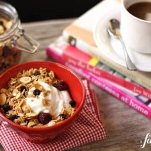 a bowl of yogurt with Granola and a cup of coffee
