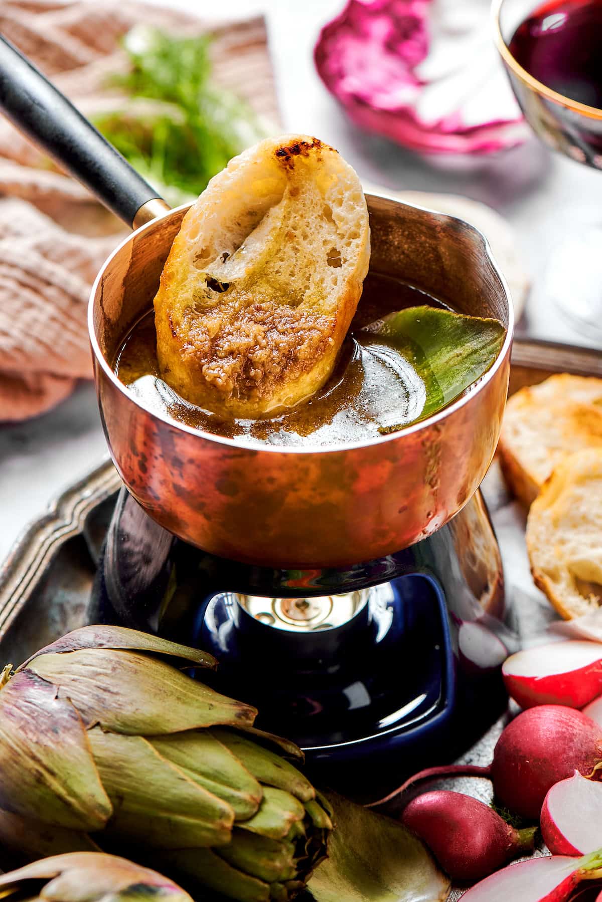 This Bagna Cauda dip is packed full of garlic and anchovies for big flavor — and it's loads of fun to eat! Easy to make in just 30 minutes! Dipping bread into bagna cauda sauce