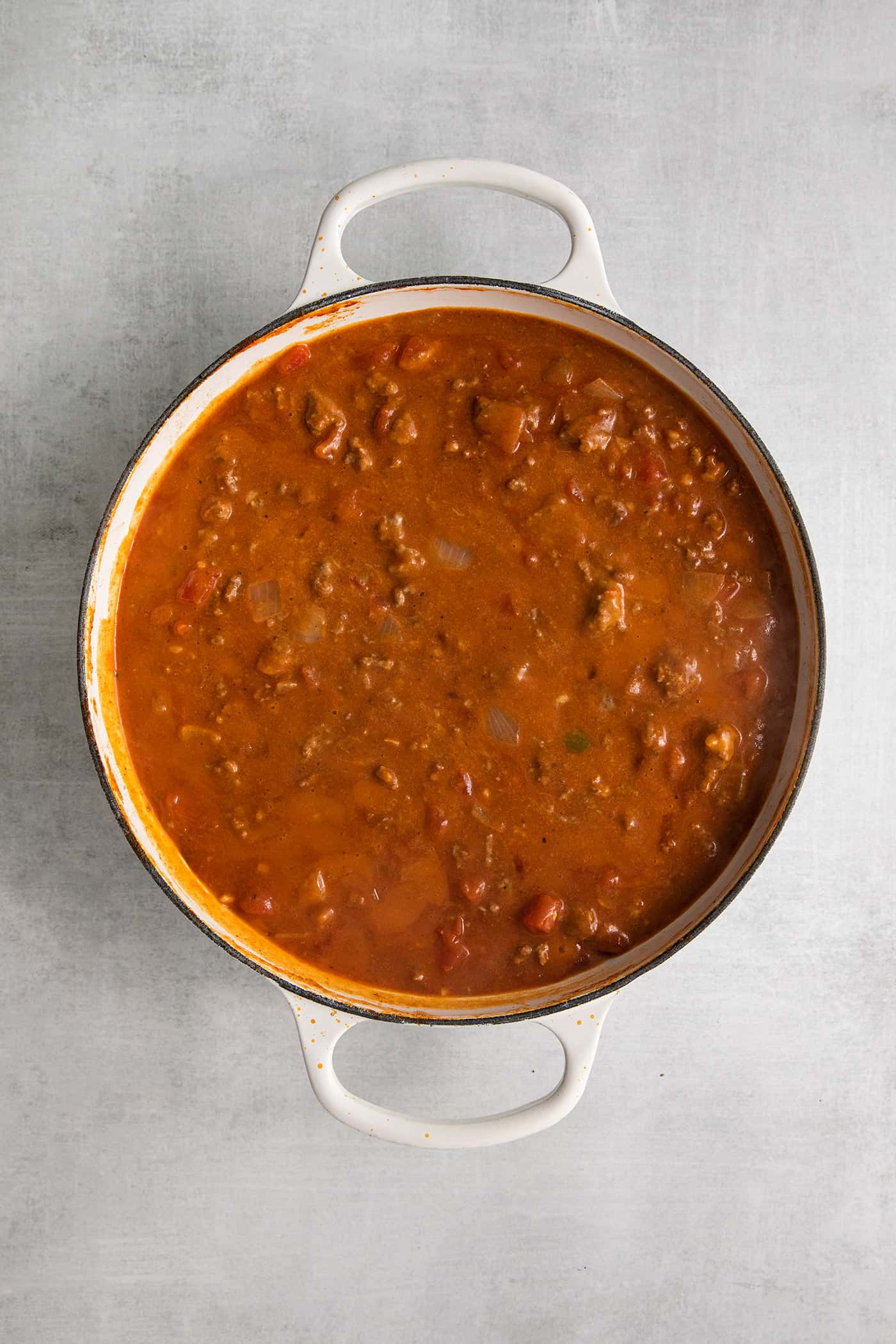 This Cheesy Beef Taco Dip is full of the beefy taco flavor you love, with ground beef, taco seasoning, Rotel, and loads of cheddar cheese. Beef rotel dip in a skillet