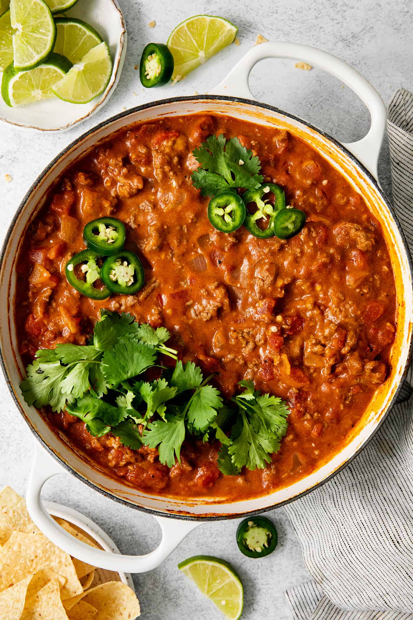 This Cheesy Beef Taco Dip is full of the beefy taco flavor you love, with ground beef, taco seasoning, Rotel, and loads of cheddar cheese. Cheesy taco dip with ground beef in a skillet