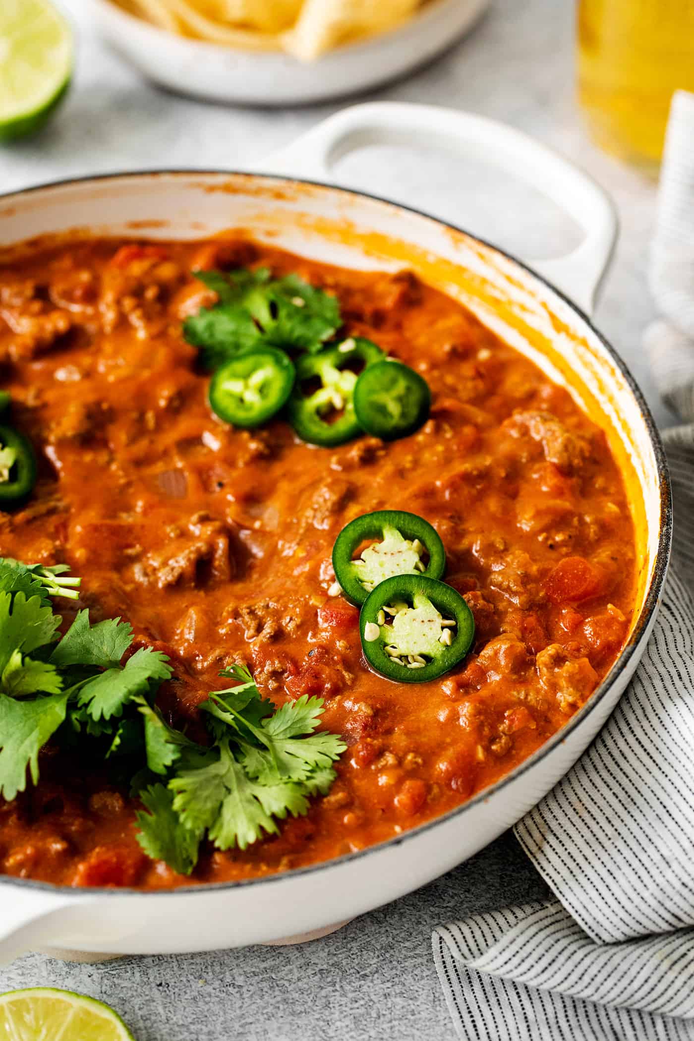 This Cheesy Beef Taco Dip is full of the beefy taco flavor you love, with ground beef, taco seasoning, Rotel, and loads of cheddar cheese. Cheesy ground beef taco dip topped with sliced jalapenos