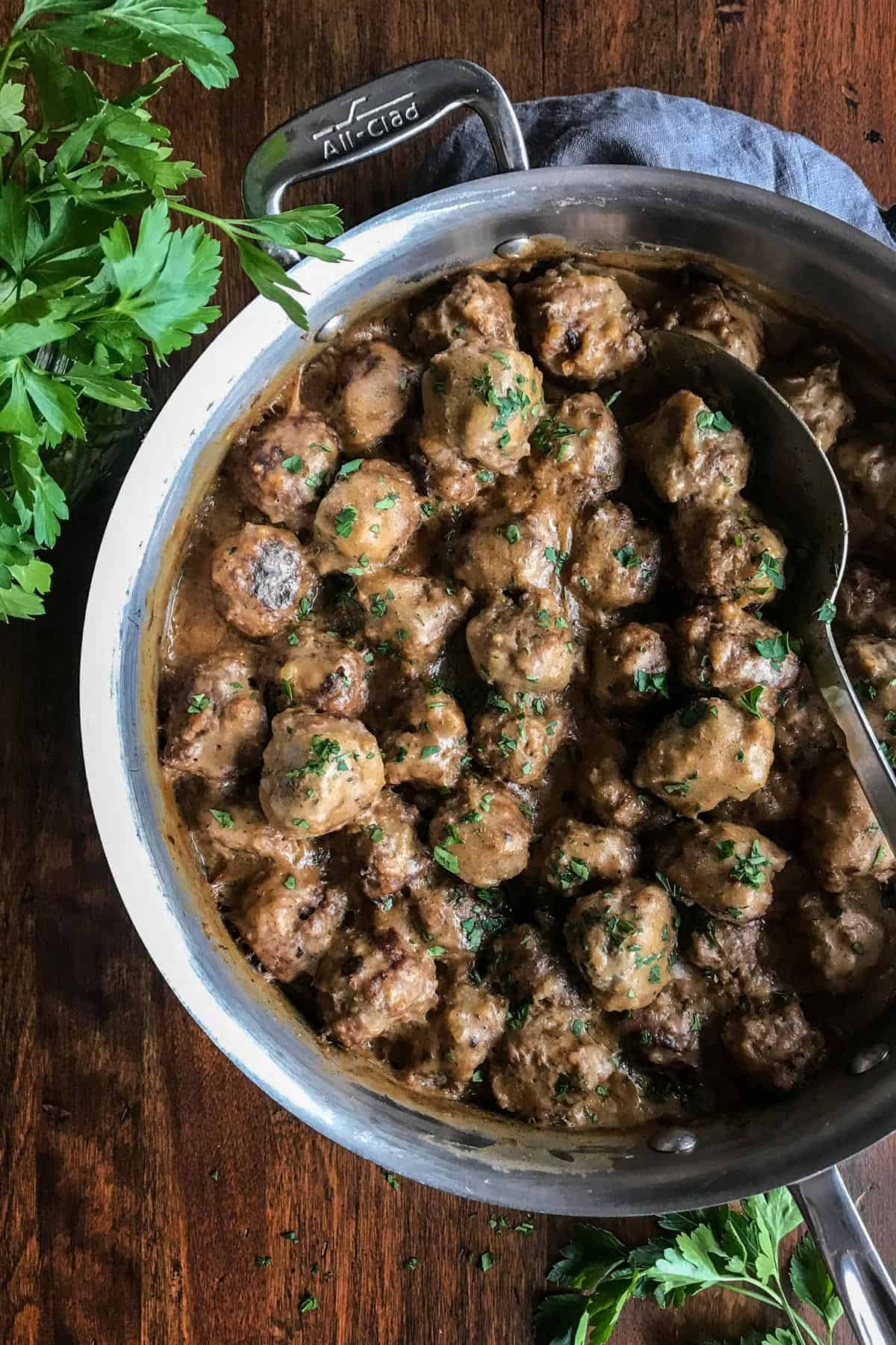 This easy Swedish meatballs recipe makes juicy, tender meatballs with a rich, creamy gravy. A homemade version of IKEA Swedish meatballs! Overhead view of homemade IKEA Swedish meatballs with gravy in skillet.