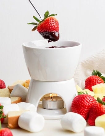 Strawberry dipped into chocolate fondue