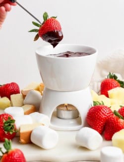 Strawberry dipped into chocolate fondue