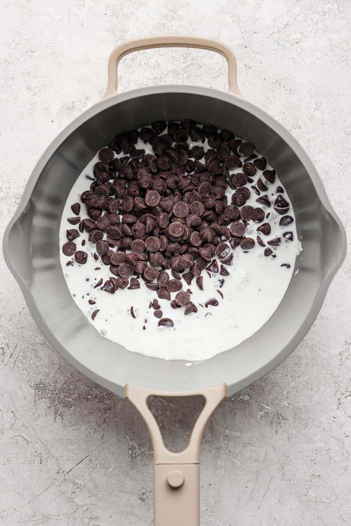 A secret ingredient makes this easy Chocolate Fondue the best ever! It’s rich, decadent and thick enough to stick to all your dippers. Cream and chocolate chips in pan