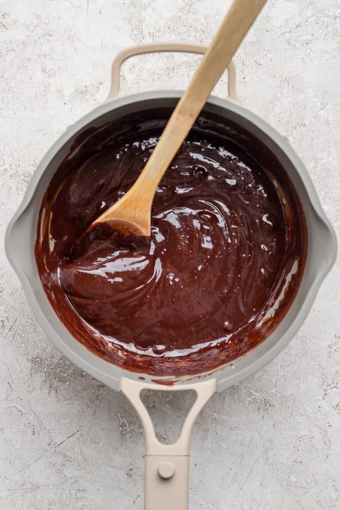 A secret ingredient makes this easy Chocolate Fondue the best ever! It’s rich, decadent and thick enough to stick to all your dippers. Stirring melted chocolate and cream in pan