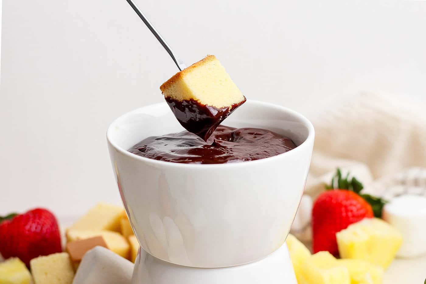 A secret ingredient makes this easy Chocolate Fondue the best ever! It’s rich, decadent and thick enough to stick to all your dippers. Dipping poundcake into chocolate fondue