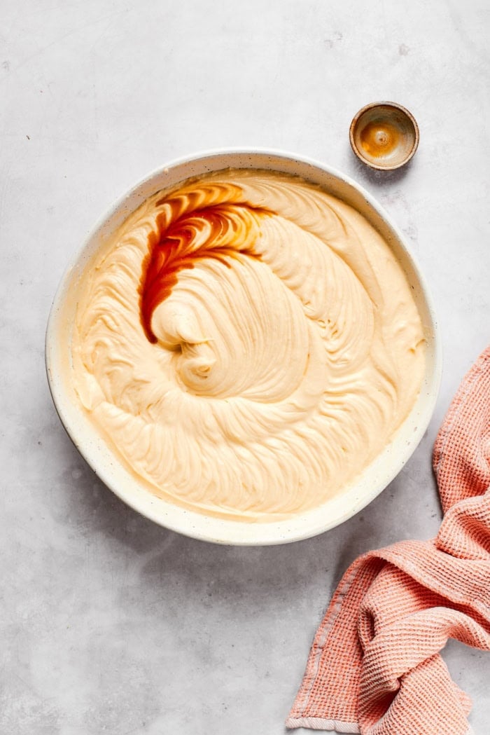 This cream cheese pound cake is a simple 6-ingredient recipe that’s rich, buttery, and perfectly dense with a velvety crumb. The best! Vanilla extract added to bowl of cake batter.