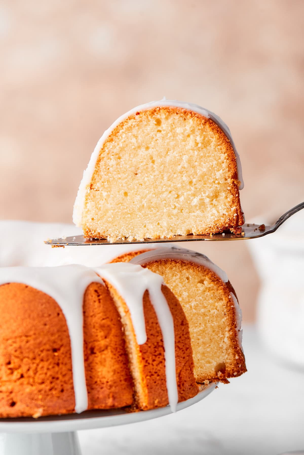 This cream cheese pound cake is a simple 6-ingredient recipe that’s rich, buttery, and perfectly dense with a velvety crumb. The best! Slice of cream cheese pound cake on spatula.