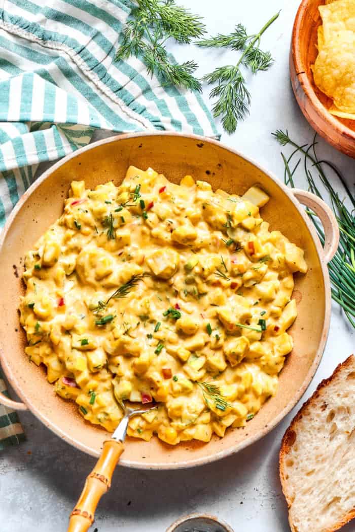 Creamy egg salad gets a fresh lift from bright herbs, making this egg salad sandwich a simple lunch that tastes anything but ordinary! Bowl of herbed egg salad with spoon.