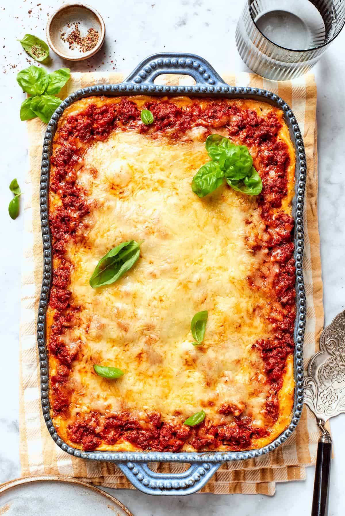 Meaty sauce, super fun spaghetti noodles, and pockets of Cheesy Yum make this Spaghetti Casserole an instant hit with the whole family! Overhead view of spaghetti casserole in baking dish