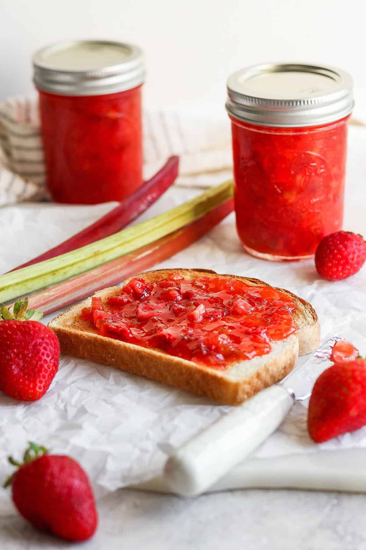 With the right balance of sweet and tart, this strawberry rhubarb freezer jam is a delight — and you don't need canning equipment to make it! Slice of bread topped with homemade strawberry rhubarb jam