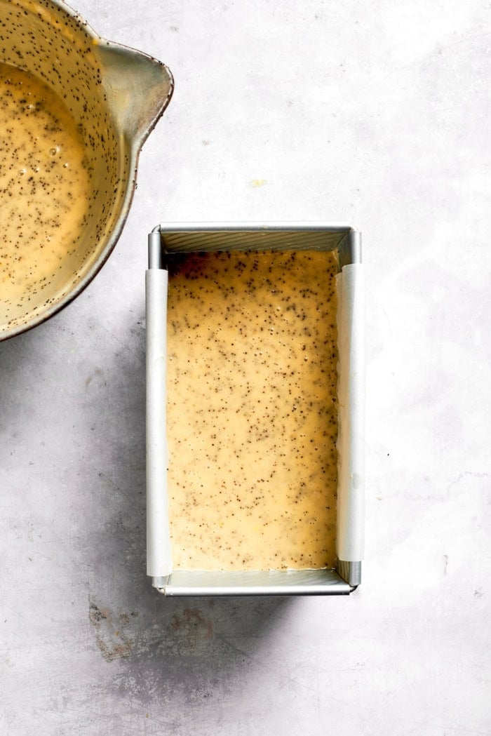 This Almond Lemon Poppy Seed Bread is soft, moist and citrusy. Topped with a zesty glaze, it’s breakfast bread worth getting out of bed for! Batter for almond lemon poppy seed bread in pan.