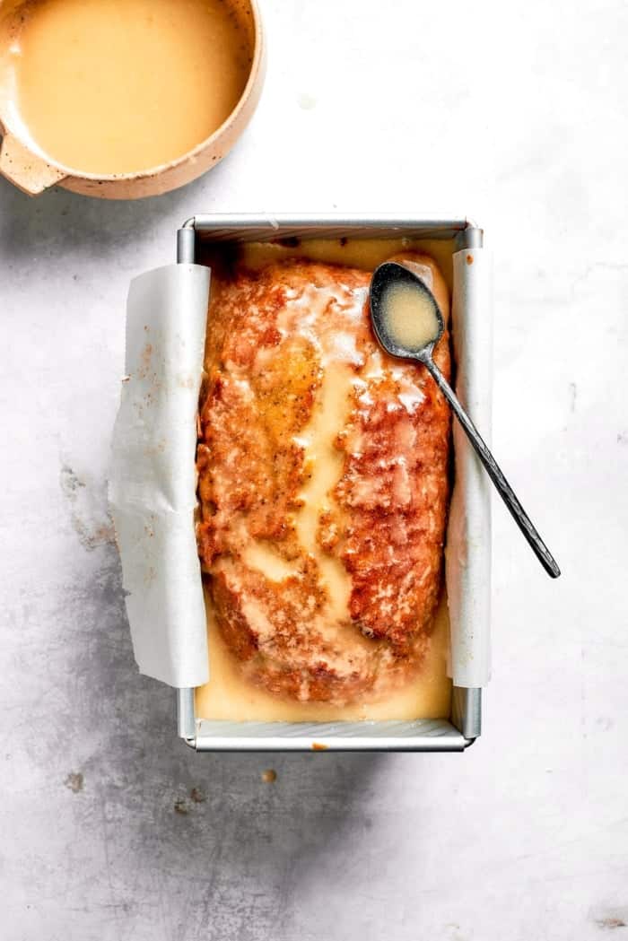 This Almond Lemon Poppy Seed Bread is soft, moist and citrusy. Topped with a zesty glaze, it’s breakfast bread worth getting out of bed for! Loaf of almond lemon poppy seed bread topped with lemon glaze.
