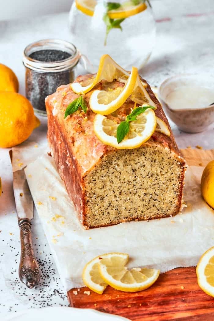 This Almond Lemon Poppy Seed Bread is soft, moist and citrusy. Topped with a zesty glaze, it’s breakfast bread worth getting out of bed for! Loaf of almond lemon poppy seed bread, cut to show moist crumb.
