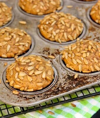 a pan of Pumpkin Muffins topped with Honeycomb Sunflower Kernels