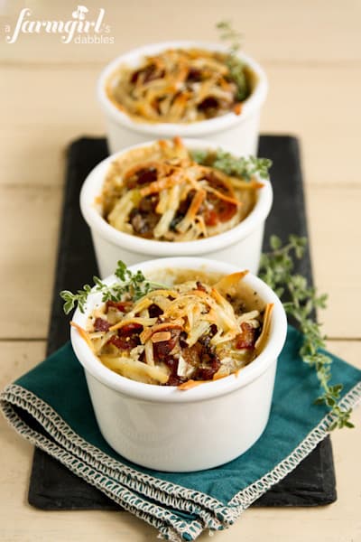 a black serving board of Individual Potato Gratins