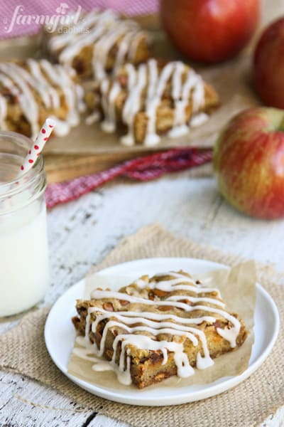 Tender baked apples, sweet cinnamon chips, and a cozy cardamom glaze make these easy homemade apple bars truly special! Apple Bars drizzled with a Cardamom Glaze.