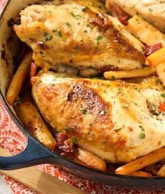 chicken breasts, hard cider, parsnips in a dark blue casserole dish