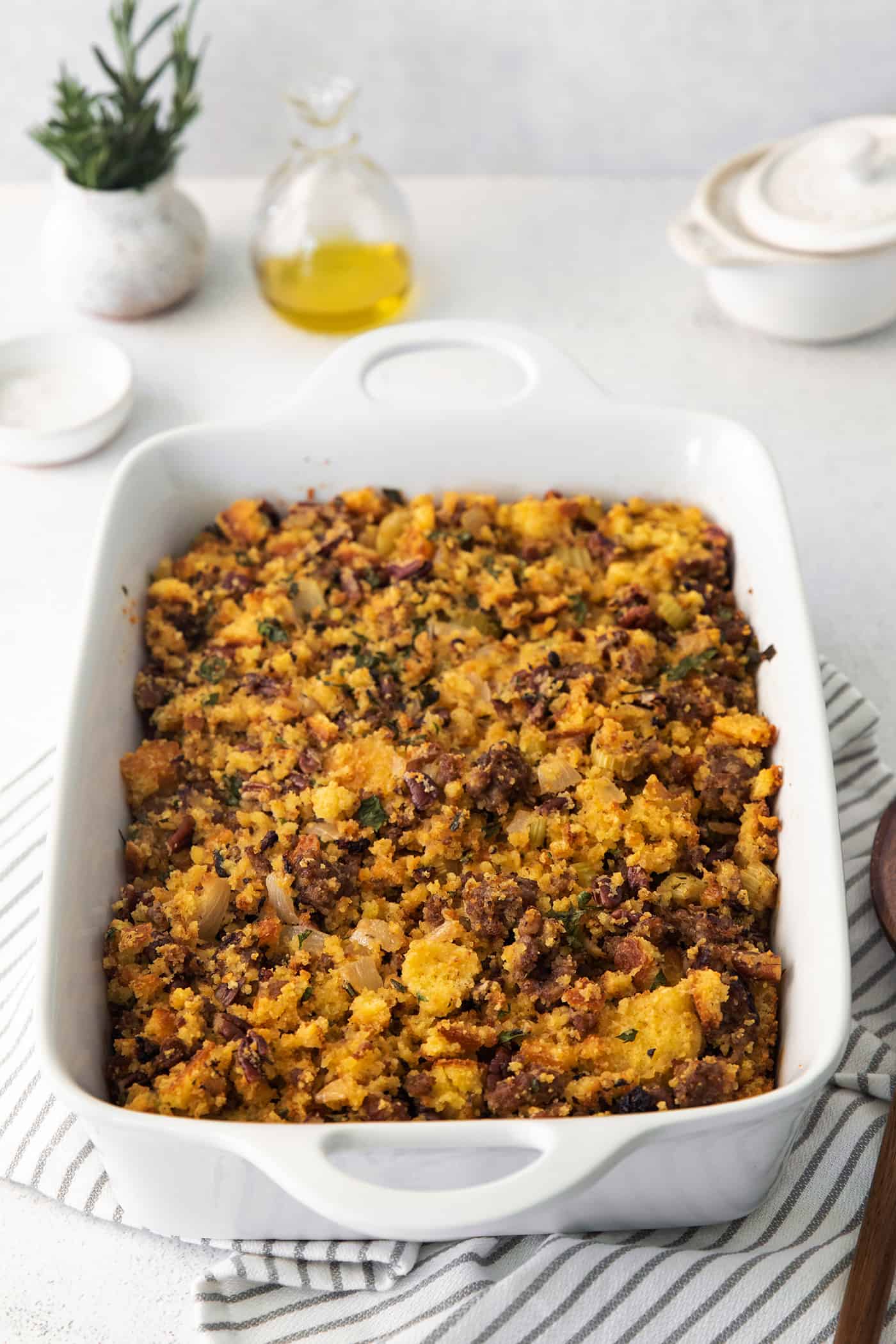 Cornbread sausage dressing in a white casserole dish