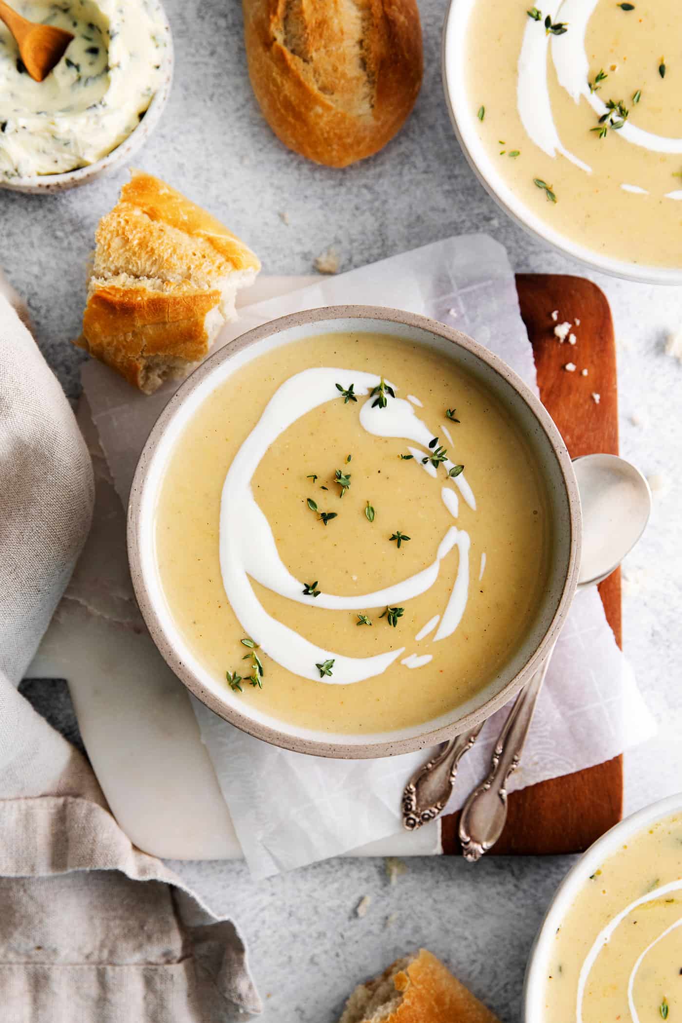 This Creamy Potato Soup with Herby Compound Butter gets everything right. It's silky smooth, rich but not heavy, and lightly buttery. Overhead view of a bowl of creamy potato soup