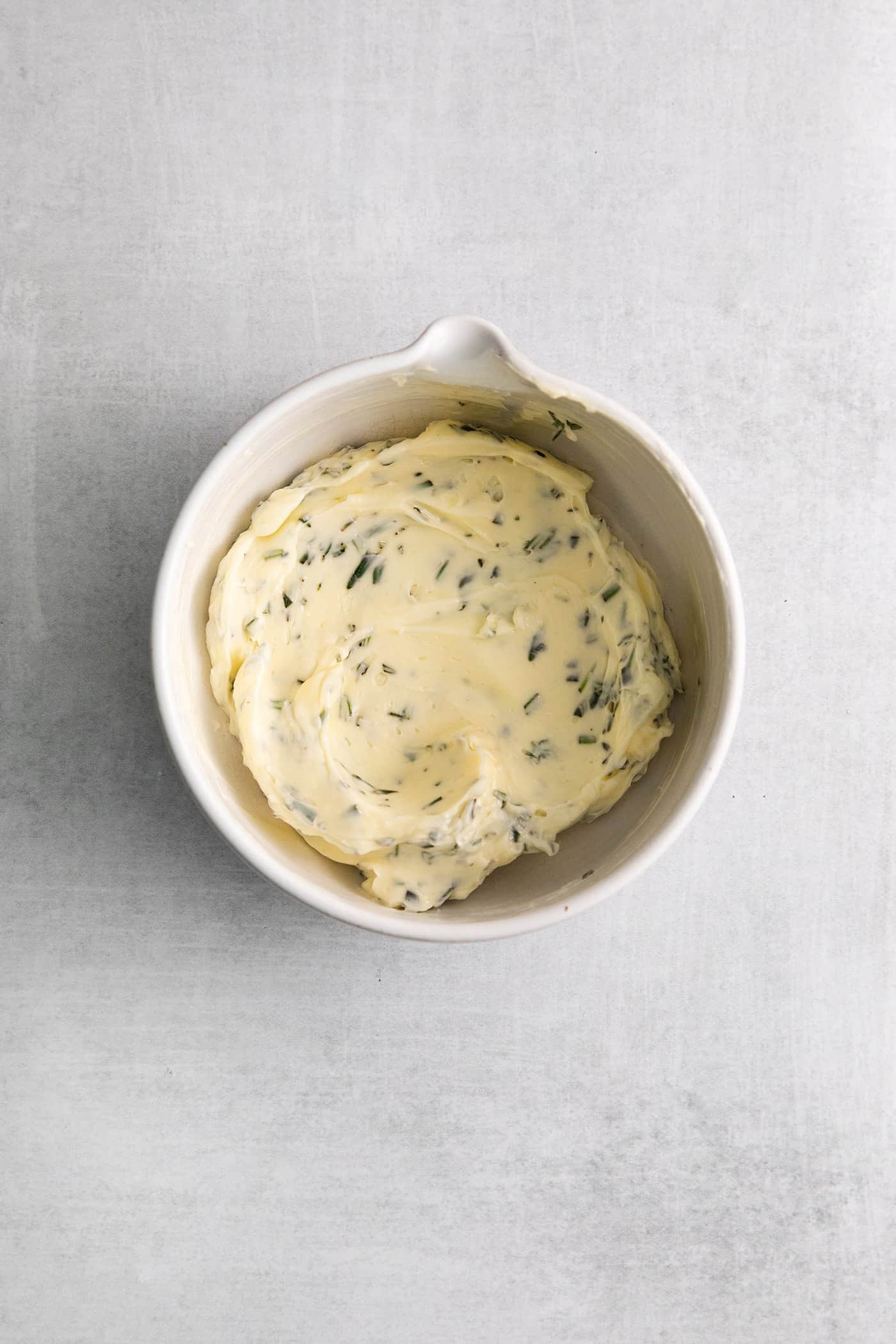 This Creamy Potato Soup with Herby Compound Butter gets everything right. It's silky smooth, rich but not heavy, and lightly buttery. Herby compound butter in a white dish