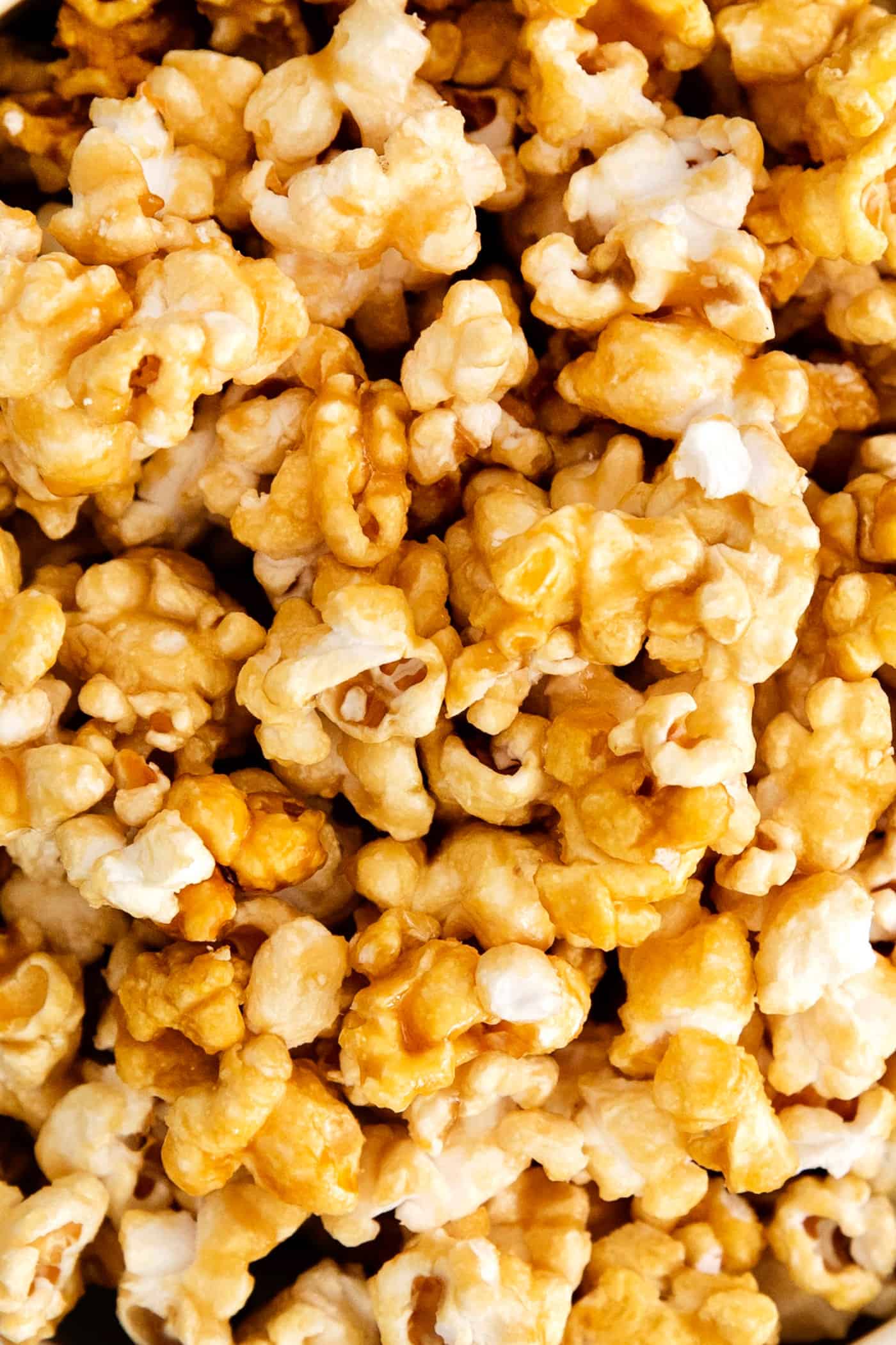 Microwave Caramel Popcorn is ready in just 15 minutes, with a handful of ingredients, a microwave, and a brown paper bag. Close up of microwave caramel popcorn