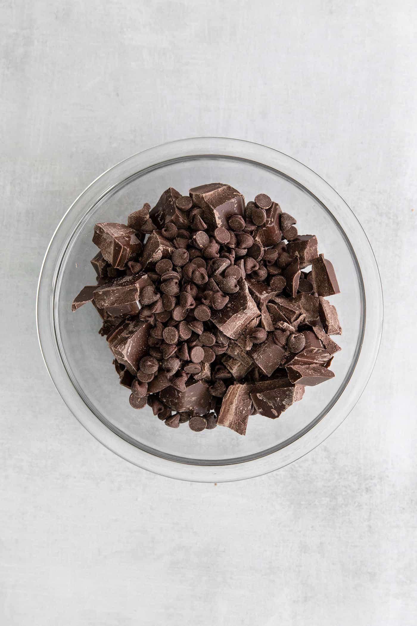Made with just 5 ingredients, these Homemade Peanut Butter Cups are a million times better than anything you can buy at the store. Chocolate chips and chocolate bark in a mixing bowl