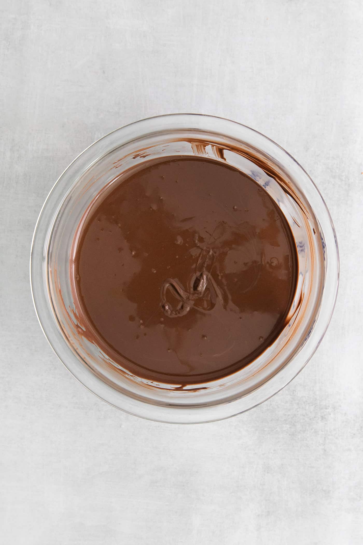 Made with just 5 ingredients, these Homemade Peanut Butter Cups are a million times better than anything you can buy at the store. Melted chocolate in a mixing bowl