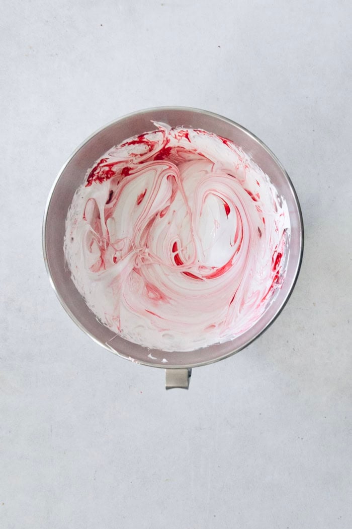 Homemade peppermint marshmallows are fluffy, festive, and so delicious! They're perfect for gifting, hot cocoa, and holiday treats. Peppermint marshmallow mixture in bowl.