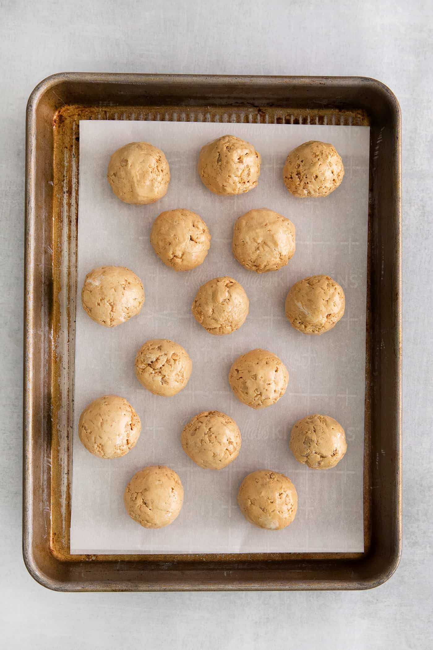 Made with just 5 ingredients, these Peanut Butter Truffles with Rice Krispies and Marshmallows are the perfect bite-sized treat. Peanut butter balls on a baking sheet