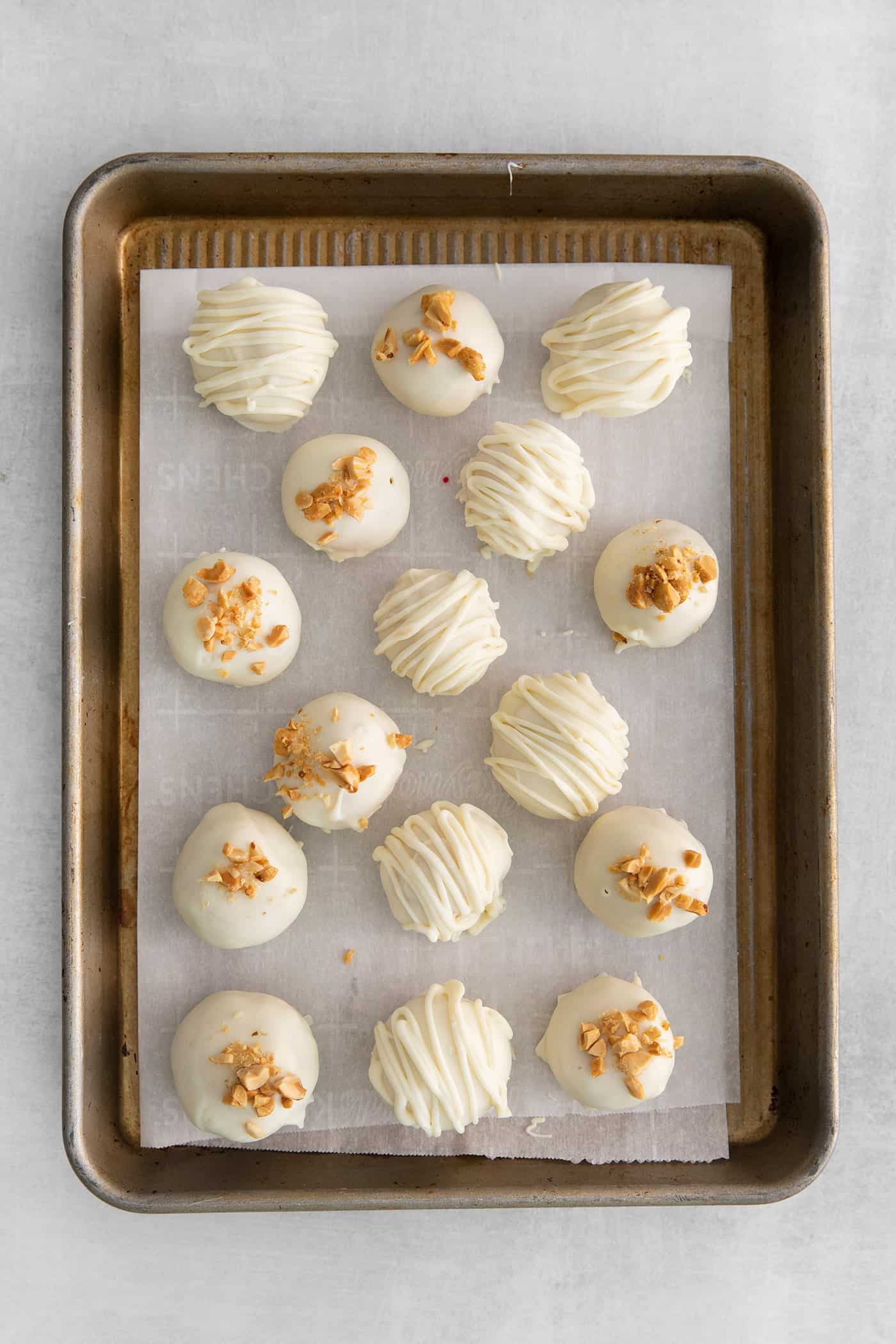 Made with just 5 ingredients, these Peanut Butter Truffles with Rice Krispies and Marshmallows are the perfect bite-sized treat. White chocolate peanut butter balls topped with crushed nuts