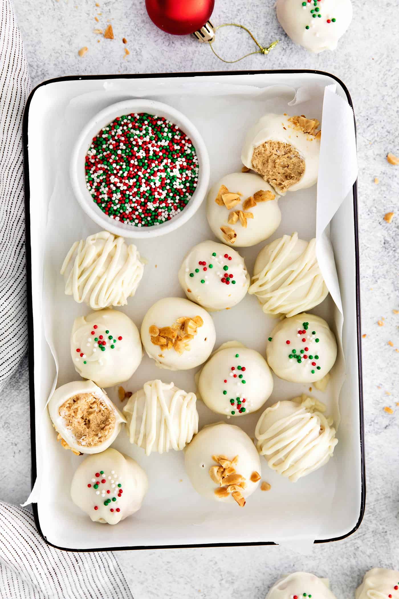 Made with just 5 ingredients, these Peanut Butter Truffles with Rice Krispies and Marshmallows are the perfect bite-sized treat. Overhead view of peanut butter balls with Christmas sprinkles