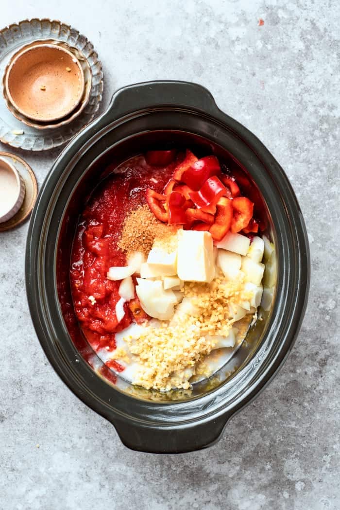 With fall-apart tender beef, fragrant spices, and a creamy coconut broth, this easy Slow Cooker Beef Curry is even better than takeout! Overhead view of ingredients for beef curry added to crockpot