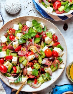 Overhead view of chopped greek Salad in bowl with spoon