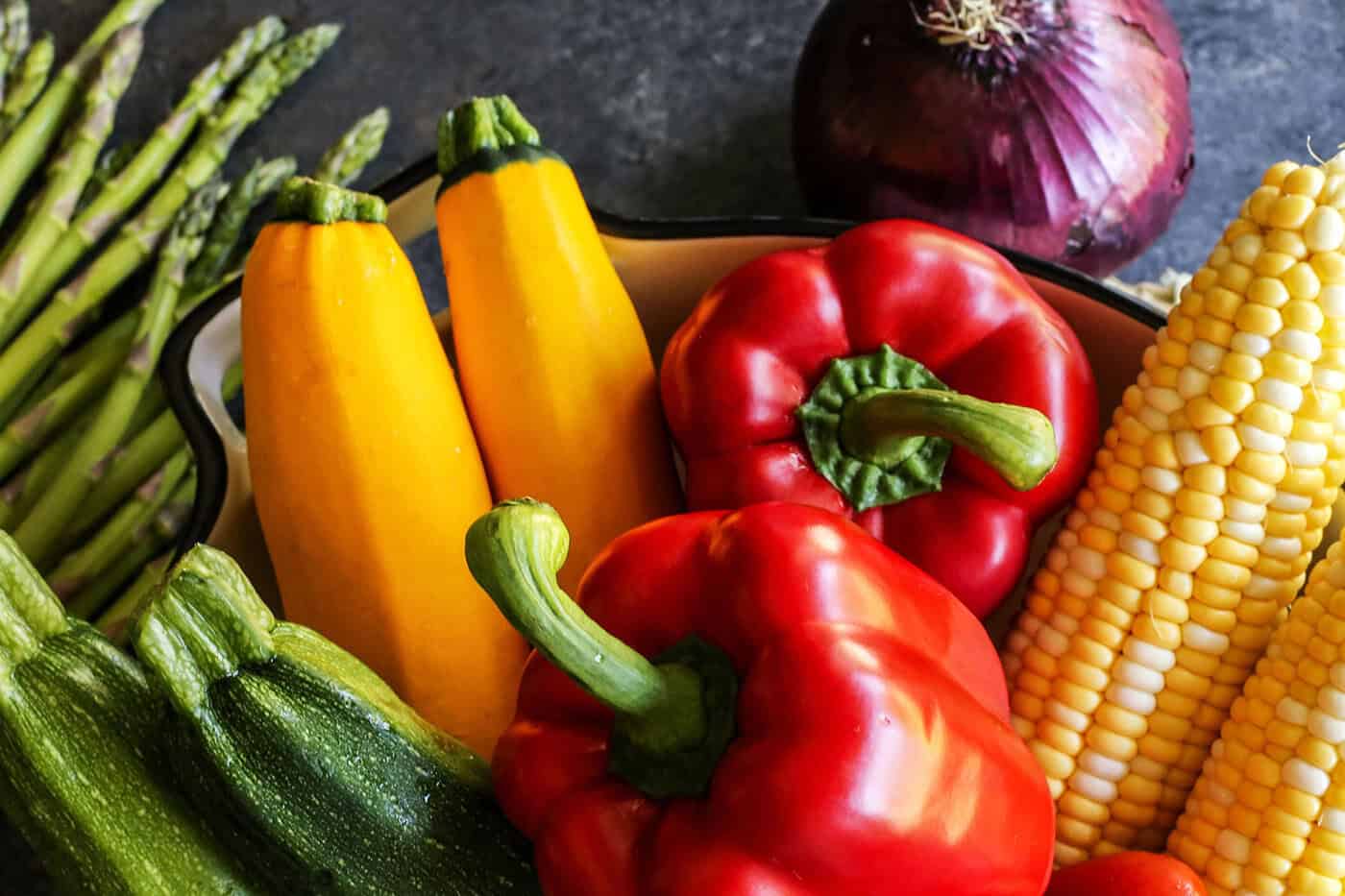 Closeup of summer vegetables piled into pan
