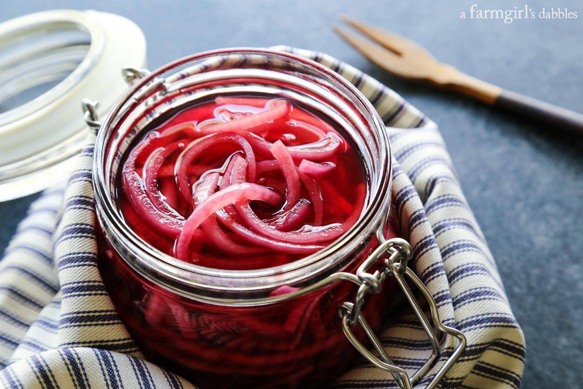 This quick pickled red onions recipe is so good! This is the easiest and most flavorful way to make pickled red onions in the fridge. Jar of quick pickled red onions
