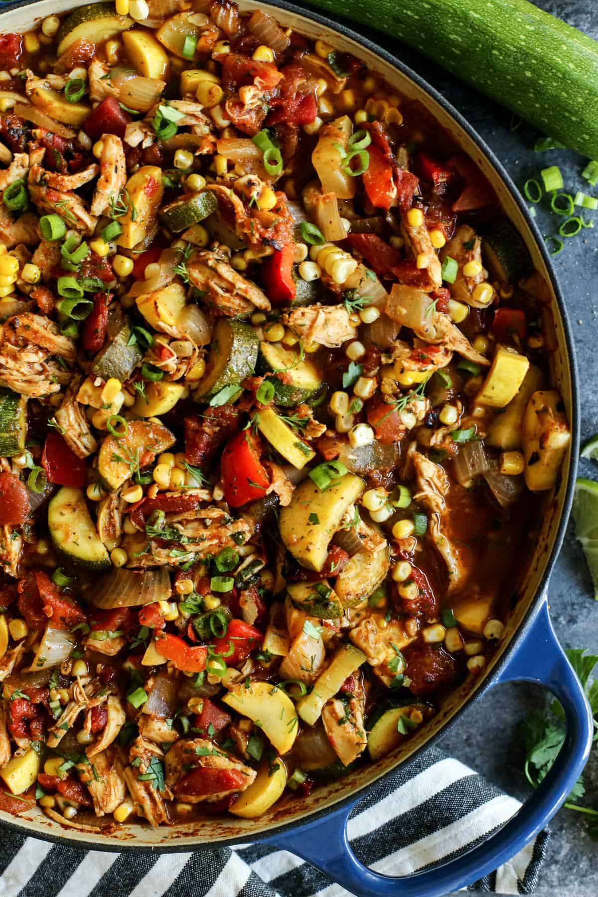 Shredded chicken and summer vegetables are the stars of this Chicken Chili recipe that's packed with zucchini, summer squash, and fresh herbs. a pot of Summer Chicken Chili