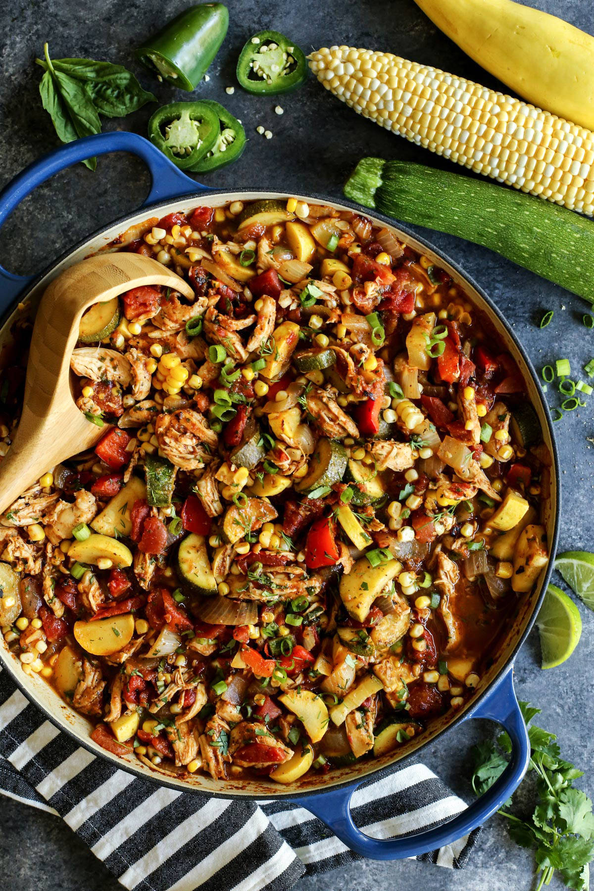 Shredded chicken and summer vegetables are the stars of this Chicken Chili recipe that's packed with zucchini, summer squash, and fresh herbs. End of Summer Chicken Chili in a blue pot.